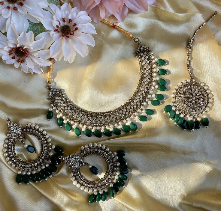 This choker comes in two styles with green or white colors as beads. It is extremely versatile and simple enough to wear for any occasion but can be worn for any evening glam as well! Perfect for the subtle but statement look! Green Desi Jewelry, Green Jewelry Sets For Wedding And Eid, Green Kundan Necklace For Eid Wedding, Silver Kundan Necklace For Wedding Bollywood Style, Silver Chandbali Kundan Necklace For Marriage, Green Jewelry For Wedding On Eid, Green Jewelry For Wedding And Eid, Green Kundan Choker For Wedding, Silver Chandbali Bridal Necklace