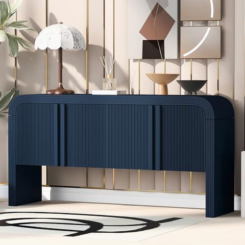 an art deco console unit in blue and gold with modern artwork on the wall behind it