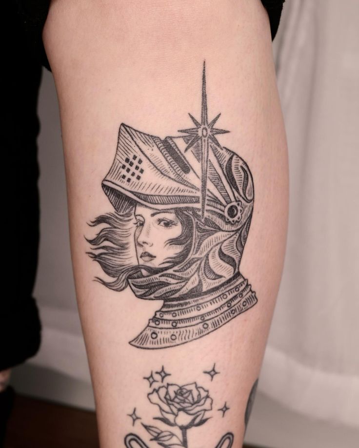 a woman's leg with a tattoo on it and a clock in the background