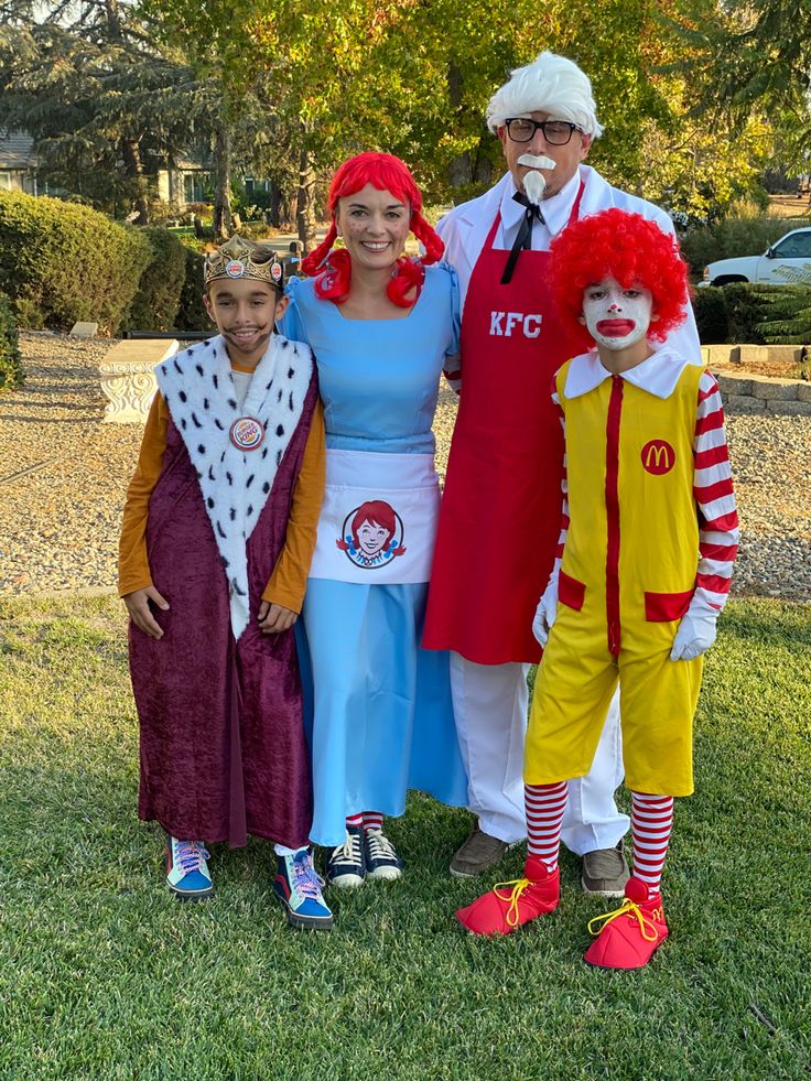 three adults and two children dressed up in costumes