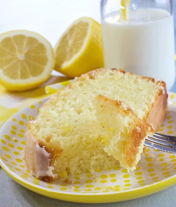 a piece of cake on a yellow and white plate with a fork next to it