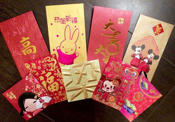 there are many cards on the table with chinese characters and symbols around them, including an envelope