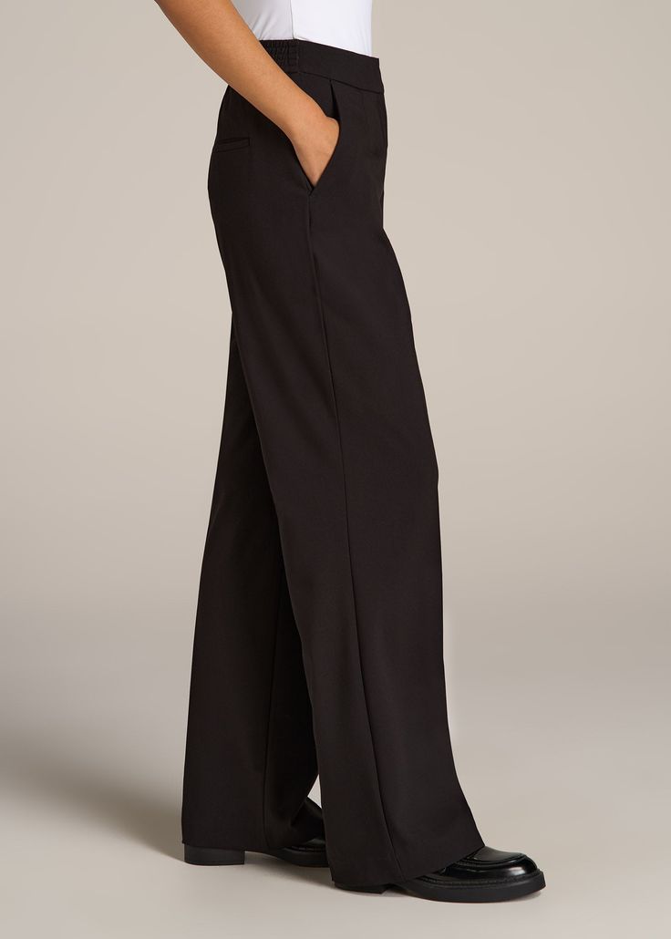 About Our Flat Front Wide Leg Dress Pants for Tall Women Ultra-flattering and easy to wear, these women's tall dress pants are a closet essential. They feature a smooth front with a contoured waistband for a complimentary finish. Pleated accents at the front and back elongate your legs and make them easy to wear from the desk to dinner. Built with a stretch-infused polyester-viscose blend, these pants for tall women offer the sleek feel of a suit with the comfort of a lounge pant. An elastic at Slacks With Heels, Pants For Tall Women, Tall Dress, Women In Black, Tall Dresses, Wide Leg Dress Pants, Closet Essentials, Black Dress Pants, Tall Women