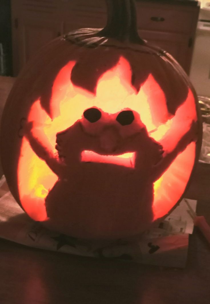 a carved pumpkin with an evil face on it