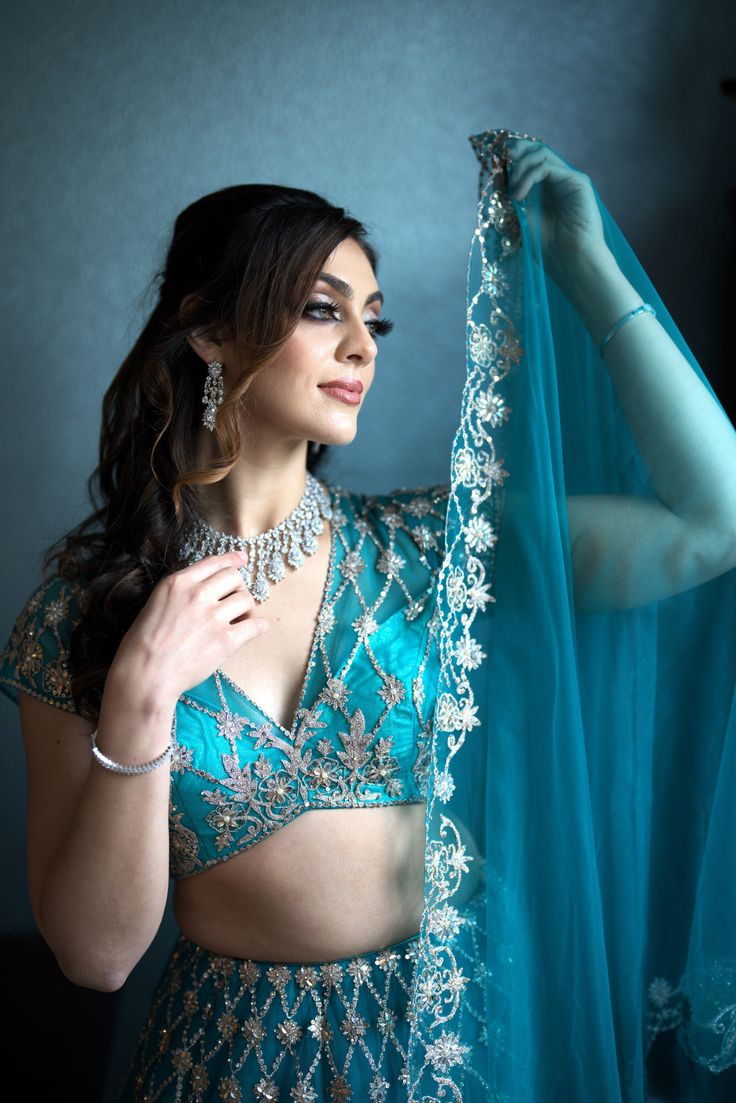 Elevate your beauty with the Magnolias ensemble. Embrace your inner fashionista in this stunning teal Priyanka lehenga adorned with exquisite embroidery and sequins, sure to catch every eye. Pristine elegance meets craftsmanship. A celebration of color and design, the Magnolias ensemble inspires the artist in you. The intricate embroidery and glimmering sequins set you apart, elevating your sense of style with each step. Colour- Teal Fabric & Work Style -- Blouse: Silk with work.- Dupatta: Net d Indian Bridal Couture, Fabric Work, Blouse Silk, Teal Fabric, Work Style, Net Dupatta, Intricate Embroidery, Style Blouse, Thread Work