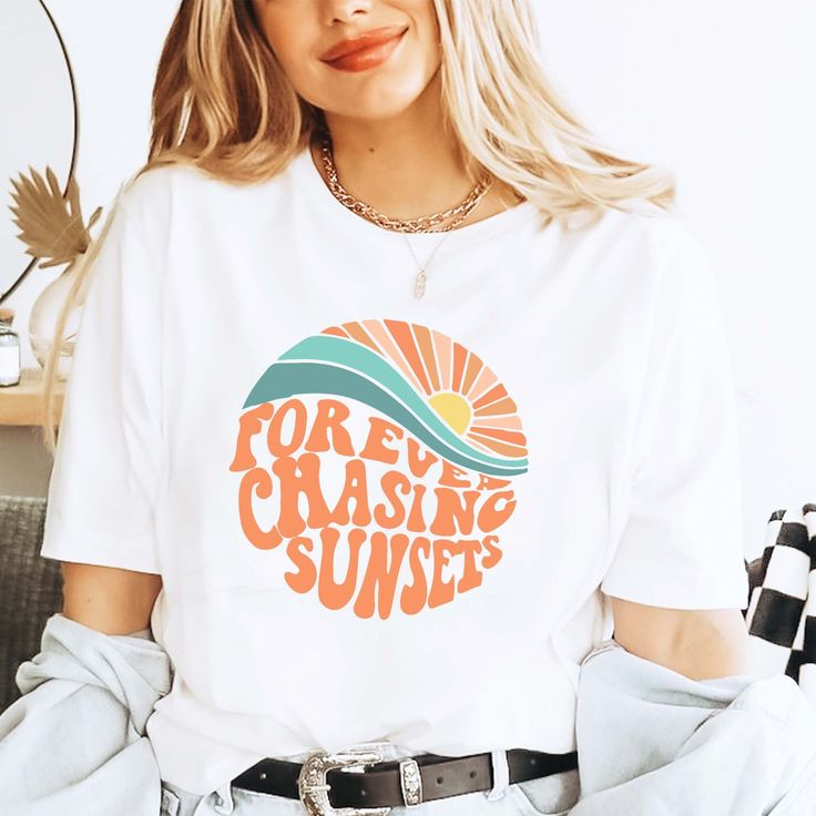 Forever Chasing Sunsets Shirt, Summer Shirt, Beach Tee, Sunset Shirt, Sunrise Shirt, Sunshine Shirt, Beachy Vibes Tee, Aesthetic Summer Tee This tee is the cutest shirt provide a fun and creative way to share the good news with friends and family, family photos and pictures. 👉HOW TO ORDER👈 1️⃣ Please review all the information provided before placing an order 2️⃣ Select the shirt type and size using the drop down menu. 3️⃣ Select the color of the shirt using the following drop down menu. 4️⃣ Need more Items? Add the current item in the cart. And If you like to add more items to your order please press the back button and repeat steps 1-3 again. 5️⃣ Once all your desired items are in your cart you may complete your order by entering your payment method, desired shipping address and click White Graphic Print Top For Summer, Retro Printed Summer Shirt, Retro Printed Shirt For Beach Season, Summer Shirt With Funny Print In Relaxed Fit, White Shirt With Text Print For Summer, Summer White Camp Shirt With Letter Print, Retro Beach Season Top For Vacation, White Summer Camp Shirt With Letter Print, Retro Beach Season Vacation Top