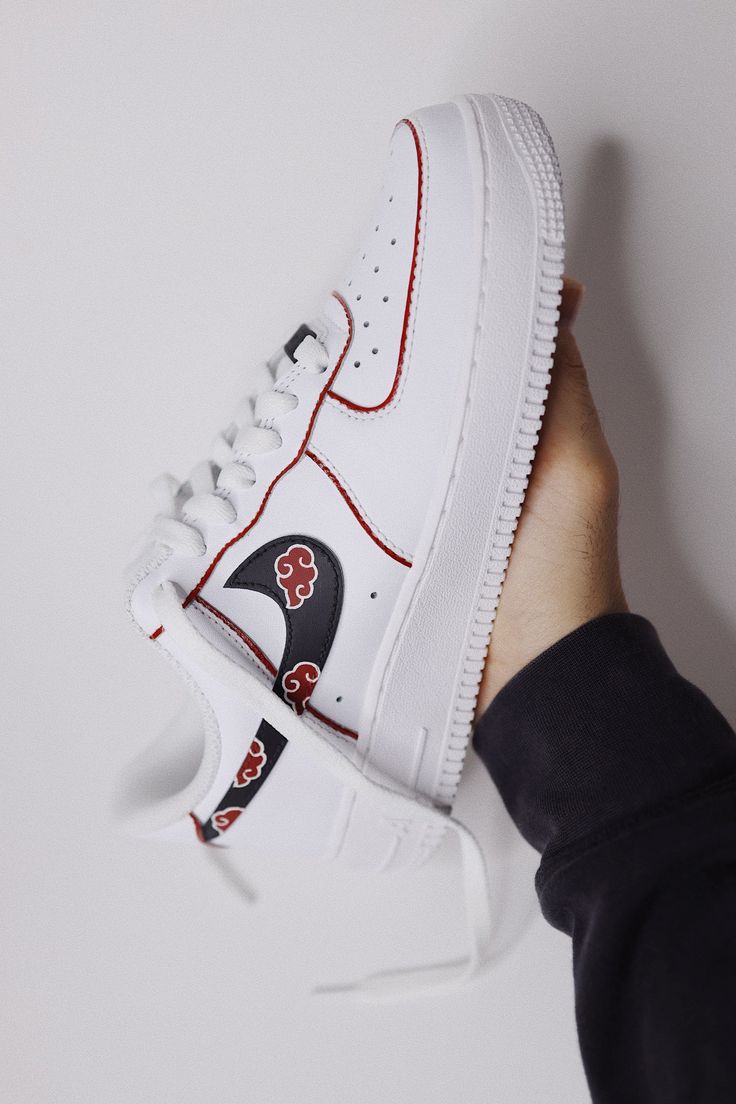 Immerse yourself in the spirit of the "Akatsuki" with our custom "Naruto-inspired" sneakers. Introducing the "Akatsuki-themed" hand-painted sneakers, featuring a sleek white canvas adorned with iconic red cloud motifs. Each pair is meticulously crafted to capture the essence of "Akatsuki", combining anime-inspired aesthetics with high-quality craftsmanship. Hand/spray "Akatsuki-themed" design. Resistant clear coat (protected against cracks and scratches). Custom made-to-order sneaker. Brand new One Piece Sneakers, White Sneakers With Anime Print For Streetwear, White Anime Print Sneakers For Streetwear, White Sporty Custom Sneakers With Anime Print, Sporty White Custom Sneakers With Anime Print, White Custom Sneakers With Anime Print For Streetwear, White Custom Sneakers With Anime Print, Hand Painted White High-top Custom Sneakers, White Hand Painted High-top Custom Sneakers