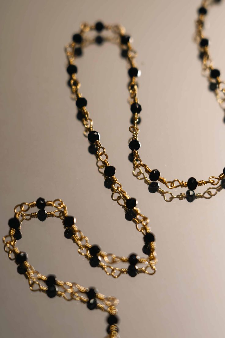 PRODUCT DESCRIPTION Bring mysterious allure to your jewelry repertoire with our Viveca Chain Necklace, featuring a row of sparkling black spinels, which is believed to revitalize, re-energize and inspire the wearer. It has a gold lobster clasp and chain, which allows you to adjust the fit to your desired drop. Gold Plated Necklace with Black Spinels Water Resistant 18k Gold-plated on High Quality Brass Black spinels 36cm in length plus 5cm adjustable chain Read our full Jewellery Care Guide here Black Jewelry With Adjustable Chain For Formal Occasions, Black Evening Jewelry With Adjustable Chain, Luxury Black Chain Necklace As A Gift, Luxury Black Jewelry With Chain Detail, Luxury Black Jewelry With Chain, Black Party Necklaces With Lobster Clasp, Elegant Black Adjustable Chain Necklace, Adjustable Black Chain Necklace With Lobster Clasp, Black Necklace With Delicate Chain For Party