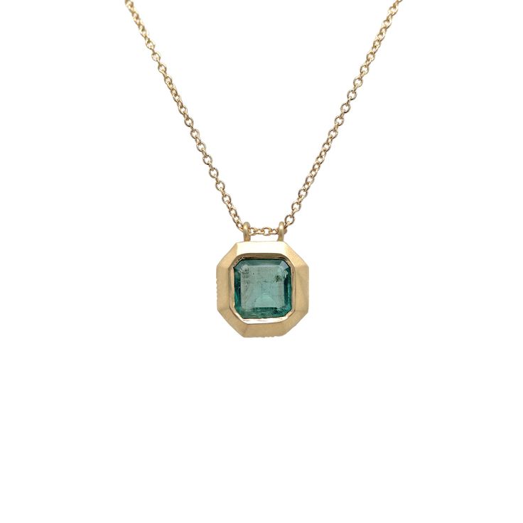 A testament to minimalist elegance, this Zambian Emerald is bezel-set in a solid gold pendant featuring delicately hand-engraved accents. White diamonds on the corners of the pendant are displayed in our signature Athena setting. Hangs from an adjustable gold chain. Metal: 14k yellow goldCenter stone: 1.08 ct Zambian EmeraldAccent stones: Four small white diamondsChain: 16-18" adjustable 14k gold cable chain Timeless Octagon Jewelry With Bezel Setting, Classic Emerald Necklace In 14k Gold With Bezel Setting, Formal Gold Emerald Necklace With Single Cut Diamonds, Formal Square Pendant Necklace With Bezel Setting, Elegant Jewelry With Bezel Setting Rectangular Pendant, Elegant 14k Gold Emerald Necklace With Bezel Setting, Elegant 14k Gold Bezel Set Emerald Necklace, Elegant Octagon Yellow Gold Necklace, Classic Yellow Gold Octagon Necklace