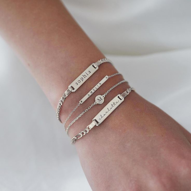 Dainty and masculine, this engravable id bracelet features a sleek bar on a Figaro chain. Perfect for layering with other bracelets or worn alone. Sterling Silver Plate measurement: Width 1in (2.7cm) x Height 0.2in (0.5cm) Italian Figaro chain, width 2mm Laser Engraving Handcrafted in NYC Hypoallergenic, lead and nickel free #B193 Engraving Bracelet, Initial Bracelet Silver, Sleek Bar, Disc Bracelet, Silver Bar, Figaro Chains, Figaro Chain, Id Bracelets, Engraved Bracelet