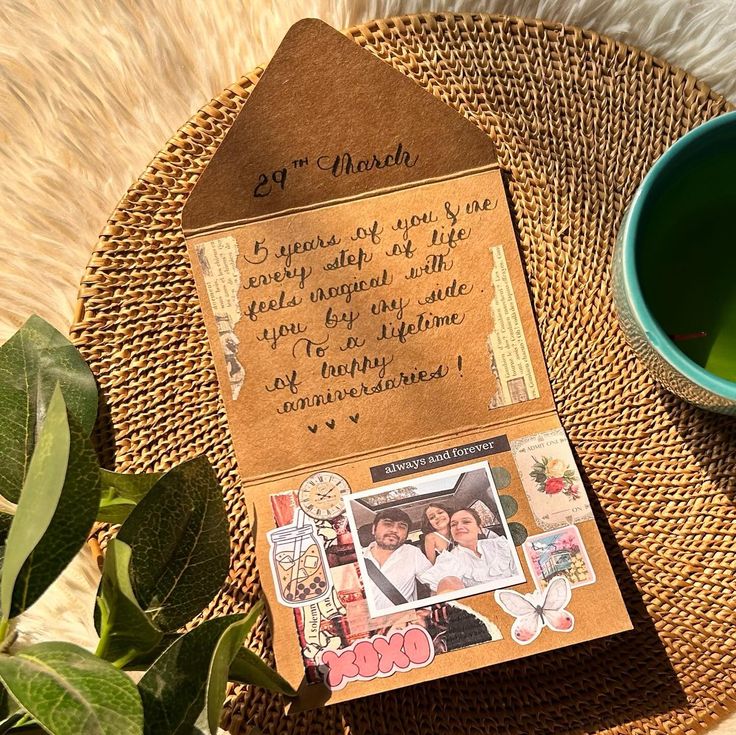 a couple's love note is placed next to a cup of tea on a wicker place mat