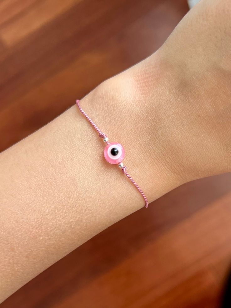 ❪ ABOUT BRACELET ❫ Pink Evil Eye is capable of keeping your friendships with others safe and is also great for providing the wearer a sense of calm and relaxation. ⎯ ❪ STEPS TO ORDER ❫ STEP 1: In the 1st drop-down, choose the "Thread Colour". * 20 colours available for thread STEP 2: In the 2nd drop-down, choose the "Beads Material" for 2mm beads beside Evil eye and the 4mm rubber bead. STEP 3: In the "Quantity", choose the quantity of the bracelet. STEP 4: Click "Add to basket" to checkout, or Adjustable Spiritual Friendship Bracelets For Birthday, Pink Adjustable Friendship Jewelry, Pink Adjustable Length Jewelry For Friendship, Gift Bracelet With Round Shape And Resizable, Resizable Bracelet As A Gift, Gift Round Bracelet, Resizable, Gift Round Resizable Bracelets, Adjustable Pink Wristband For Birthday, Gift Bracelets With Sliding Knot