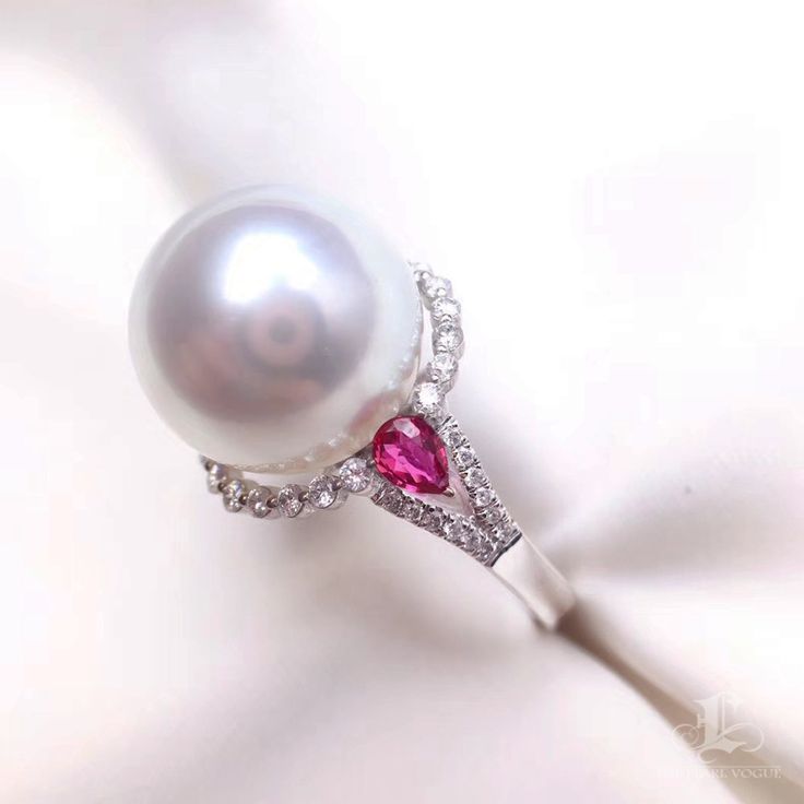 This is a beautiful ring. Product Information OriginSouth Sea Pearl Jewelry Processed in Japan MaterialSouth Sea Pearl, 18K Gold, and Natural Diamonds DimensionsCustom Pearl Shaped: Round Size: 13-14mm Quality: AAAA Nacre: Very Thick Color: White Luster: Very High Accessories Metal: 4.2g of 18k White Gold Other: 0.50ct of SI Quality Natural Diamond and 0.45ct Natural Ruby Exquisite White Platinum Ring, Luxury White Ruby Ring With Brilliant Cut, White Ruby Ring With Brilliant Cut, Luxury White Ruby Ring With Round Cut, White Round Ruby Ring In Fine Jewelry Style, White Oval Brilliant Cut Pearl Ring, White Oval Pearl Ring With Brilliant Cut, White Round Ruby Ring Fine Jewelry, Classic White Ruby Ring With Vvs Clarity