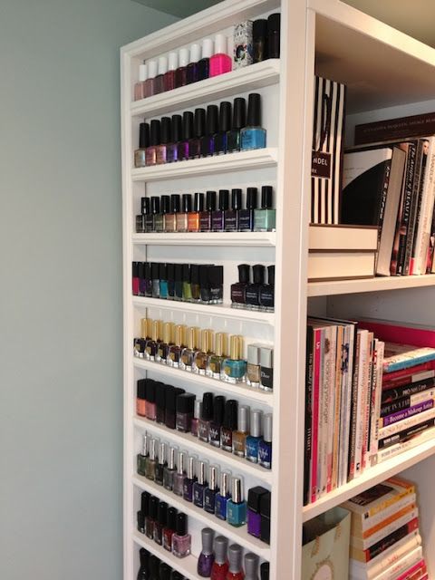 a white book shelf filled with lots of different types of nail polish and other items