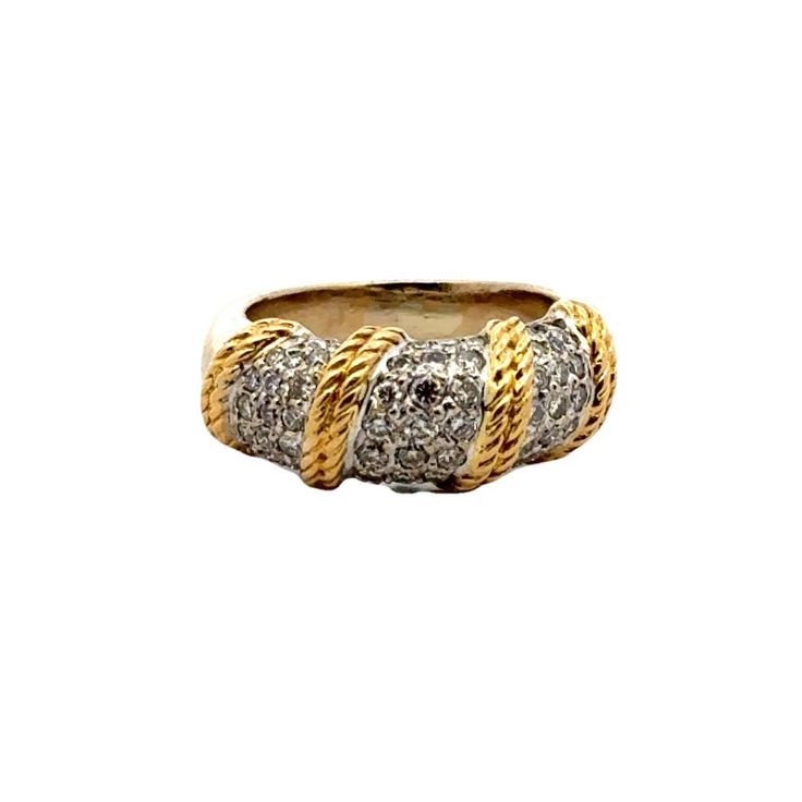 The Diamond Dome Ring with Rope Design is a striking piece that combines elegance and craftsmanship. Featuring a dome-shaped setting encrusted with 59 sparkling round brilliant cut diamonds, this ring is crafted from 18 karat yellow and white gold, highlighting a sophisticated two-tone finish. The diamonds weigh approximately 1.00 CTW and are graded H-I color and SI clarity. The intricate rope design in yellow gold adds a touch of texture and unique flair, making this ring a standout addition to any jewelry collection. The band measures 8.5mm in width and is currently size 5.5. Weight: 8.8 grams. Formal White Gold Dome Ring With Pave Setting, Classic White Gold Dome Ring With Pave Setting, Classic Dome Ring With Diamond Accents For Formal Occasions, Classic Dome Ring With Diamond Accents For Formal Events, Formal Round Dome Ring With Pave Setting, Formal Dome Ring With Diamond Accents And Oval Shape, Formal Oval Dome Ring With Diamond Accents, Elegant Diamond White Dome Ring With Diamond Cut, Fine Jewelry Oval Dome Ring With Pave Setting