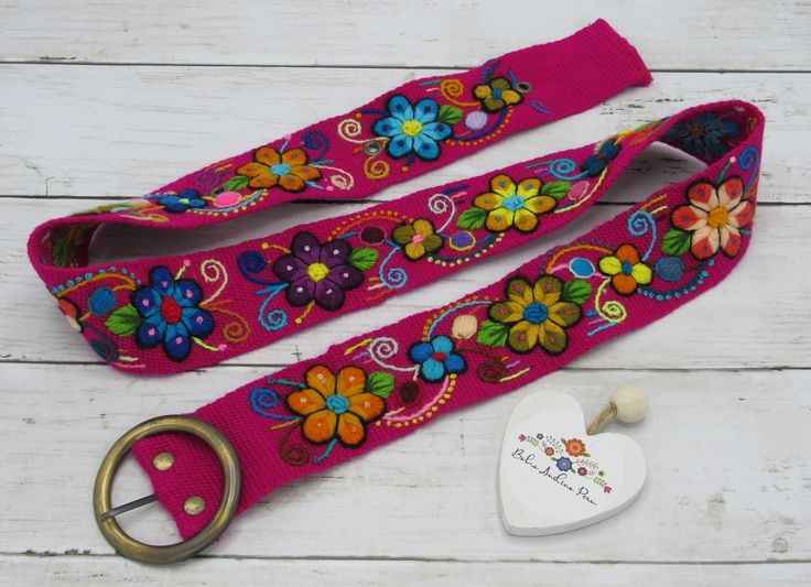 Peruvian embroidery flowers belts of wool material made with natural dyes with vibrant colors. Each fabric has a unique design. These belts are handmade by artisans from Ayacucho - Peru. Perfect match with rustic buckle to give a touch of Boho- ethnic styles and enhance your outfit. You can wear the same belt on your waist or hips, They also stretch slightly *PLEASE CHECK SIZES BEFORE YOU ORDER* This belt measures: ♥Color: FUCHSIA ♥Size: S/M ♥Belt width: 2 in ♥Total Length 41 in ♥Length to first Multicolor Fabric Belt In Folk Style, Folk Style Multicolor Fabric Belt, Multicolor Folk Fabric Belt, Adjustable Multicolor Bohemian Belts, Artisan Multicolor Fabric Belt, Folk Style Multicolor Embroidered Belt, Folk Multicolor Embroidered Belt, Adjustable Artisan Multicolor Belt, Adjustable Handmade Multicolor Belt