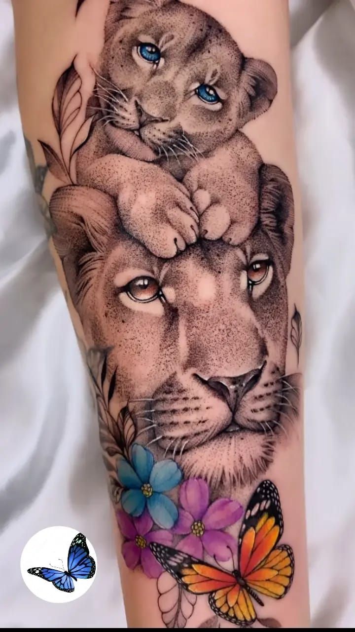 a woman's leg with a lion and butterfly tattoo on it