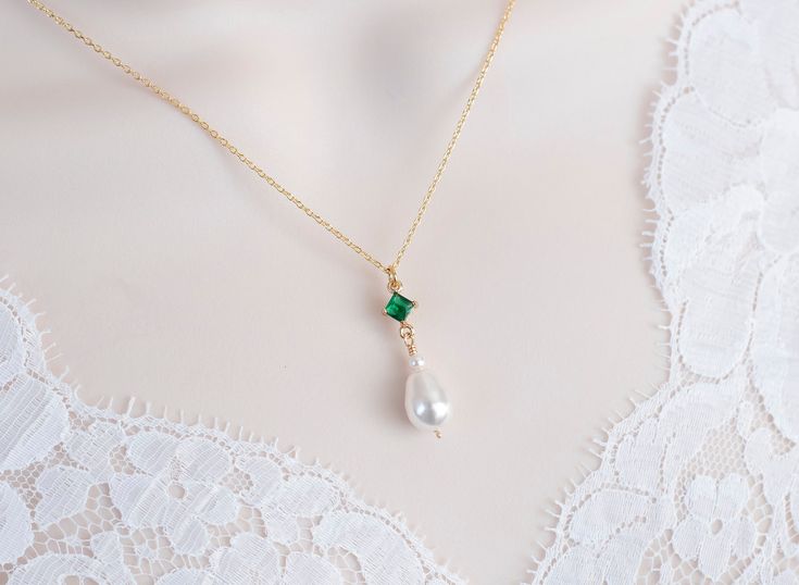 Vintage, Romantic Style Emerald Necklace, Wedding Pearl and Emerald CZ Bridal Choker, Emerald CZ Vintage Swarovski Pearl Necklace  Materials used: - White/Ivory Cream Swarovski pearls - cubic zirconia stones - gold plated over brass The necklace will arrive packaged ready for gift giving in a delicate white jewelry box with a silver ribbon. Matching earrings for this necklace:  Back to my shop http://www.etsy.com/shop/crinadesign73 Thank you for visiting my store! Emerald And Pearl Necklace, Pearl And Emerald Necklace, Dainty May Birthstone Necklaces For Weddings, Delicate Wedding Necklace With May Birthstone, Delicate May Birthstone Necklace For Weddings, Elegant Wedding Necklace With May Birthstone, Elegant May Birthstone Necklace For Weddings, Elegant Wedding Necklace For May Birthstone, Swarovski Pearl Necklace