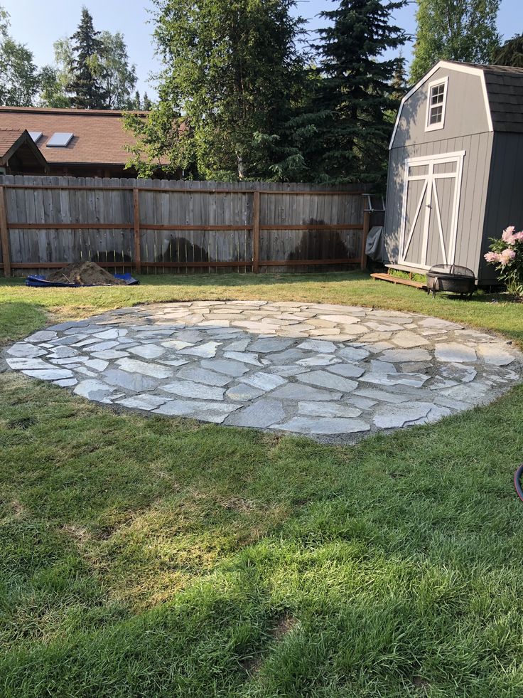 an outdoor fire pit in the middle of a yard