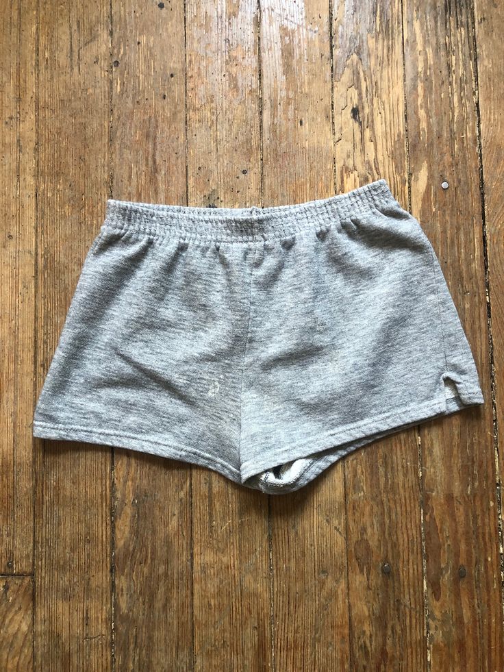 70s era grey sweat shorts from Sportswear. Booty short, short short length. Some visible staining on front. Nice condition otherwise. Plenty of stretch left in elastic. Washed and ready to wear.  See photos for measurements. Gray Shorts With Elastic Waistband, Gray Cotton Workout Shorts, Gray Loungewear Shorts, Gray Cotton Athletic Shorts, Gray High-waisted Shorts With Elastic Waistband, High-waisted Cotton Gym Shorts, Cotton High-waisted Gym Shorts, Gray High-waisted Cotton Shorts, Grey Sweat Shorts