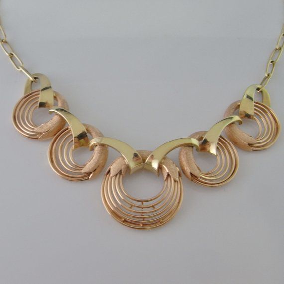 A fine hand made 1940s high art deco necklace in rose and yellow gold. This divine necklace features a central hand made focus that is hand crafted in rose and yellow gold. The design is exceptionally streamlined. The necklace measures 17" long and is 13/16" wide (432mm x 20mm). Made from fine 14K rose and yellow gold it weighs a total of 23.19 grams. It is in excellent condition.This is a one of a kind original art deco necklace not a reproduction item in the deco style. An appraisal shall acco Art Deco Necklace For Anniversary, Art Deco Round Necklace For Anniversary, Rose Gold Collectible Necklaces, Collectible Rose Gold Necklaces, Gold Art Deco Jewelry For Formal Occasions, Formal Art Deco Round Necklace, Rose Gold 14k Art Deco Jewelry, Art Deco 14k Rose Gold Jewelry, Gold Art Deco Jewelry With Polished Finish