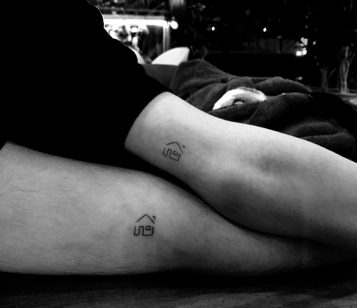 two people with matching tattoos on their legs