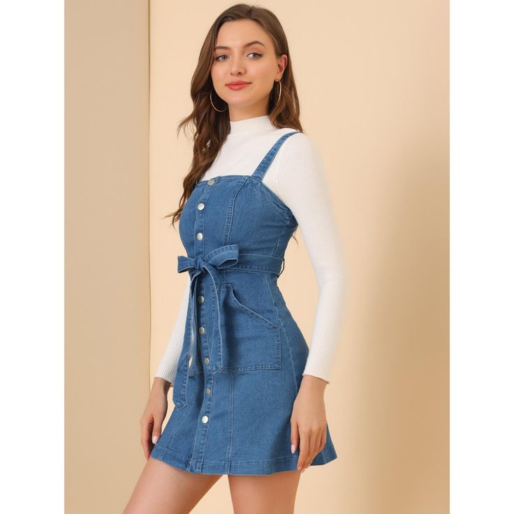 Update your weekend collection with this classic denim dress. The fit and flare dress structure adds a playfulness to your outfits and the button detailing gives a 60s-inspired feel. This jean dress features a square neck, sleeveless design, and adjustable strap. Perfect for the weekend, and paired well with trainers and a cross-body bag for an off-duty look. Retro Mini Dress With Button Closure, Retro Fit And Flare Mini Dress For Spring, Retro Mini Dress With Button Closure For Spring, Trendy Denim Blue Mini Dress With Buttons, Trendy Cotton Dress With Button Closure, Blue A-line Denim Mini Dress, Blue Denim A-line Mini Dress, Cotton A-line Mini Dress With Buttons, Retro Denim Dress With Buttons For Spring