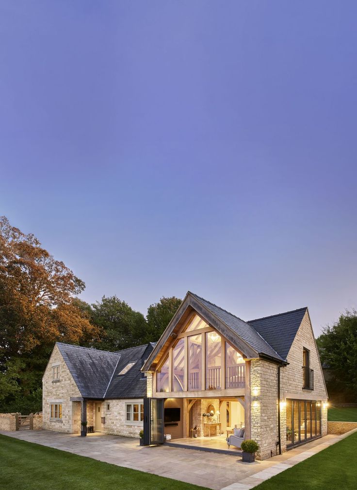 a large house that has a lot of windows on the front and side of it