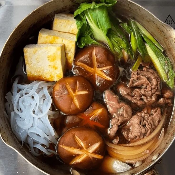 a pot filled with lots of food on top of a stove