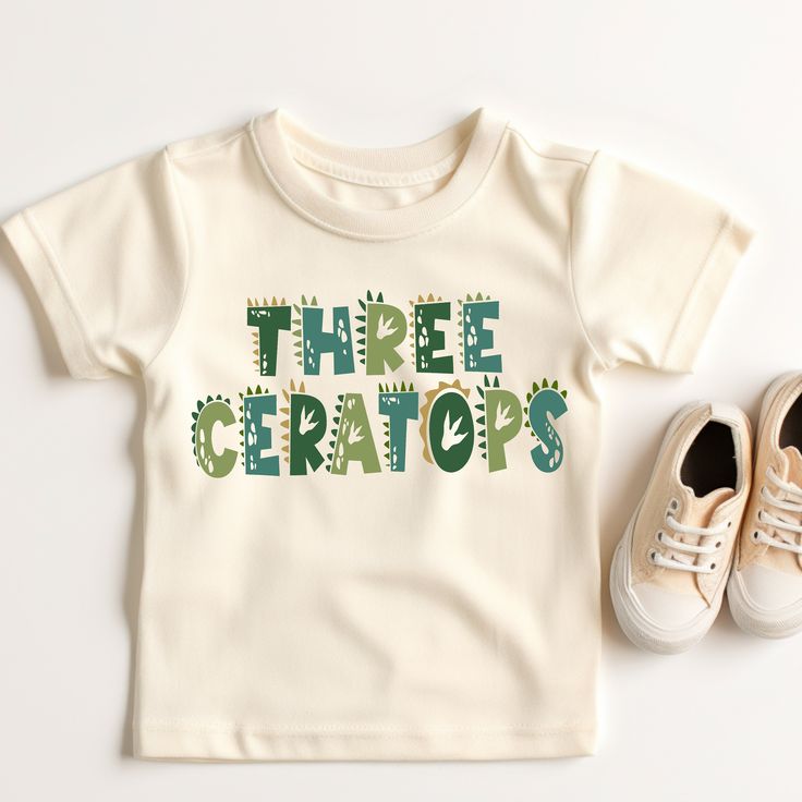 Dinosaur, ThreeCeratops Birthday shirt, unique cute shirt to remember your little one's 3rd Birthday!! Please read all the info before placing your order. The price you see is per shirt, please read the size chart in the last pictures of listings before placing your order. How to order a shirt: *Select the STYLE *Select the SIZE *Select the Quantity *Add Personalization *Add to cart *Go back and Repeat for each size (if you need more than one shirt) Shirt Color:Natural, White  100% Cotton *Shirt Green T-shirt With Dinosaur Print For Birthday, Green Dinosaur Print T-shirt For Birthday, Fitted Short Sleeve Dinosaur Print Top, Fitted Short Sleeve Tops With Dinosaur Print, Playful White Dinosaur Print Top, Fitted Cotton Tops With Dinosaur Print, Unisex Dinosaur Print Tops For Birthday, Gender-neutral Dinosaur Print Top For Birthday, Summer Dinosaur Print Top For Birthday