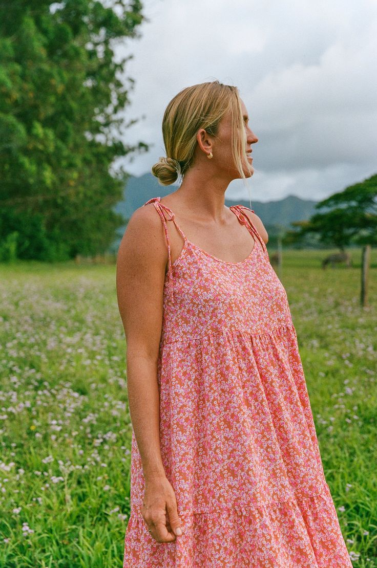 Introducing the Millie Dress, in a fun new print that is super happy and reminds us of Kauai. With tie straps, a beautiful and vibrant pink floral, and a textured fabric, you'll feel elegant and relaxed all day long. The modest neckline and perfect length add the finishing touch to this playful and stylish dress. Bethany Hamilton x CJLA Collection FIT Made in LA Easy, Flowy Fit Adjustable Tie Straps Nursing Friendly Not Stretchy, Size Up for Larger Bust Not Lined Bethany is 5'11 Wearing Size Lar Pink Vacation Dresses With Adjustable Straps, Pink Printed Sundress With Spaghetti Straps, Pink Adjustable Strap Dress For Vacation, Pink Dress With Adjustable Straps For Day Out, Pink Dresses With Adjustable Straps For Day Out, Pink Sundress With Adjustable Straps, Pink Sundress With Floral Print And Spaghetti Straps, Pink Beach Dress With Tie Straps, Pink Floral Print Sundress With Spaghetti Straps