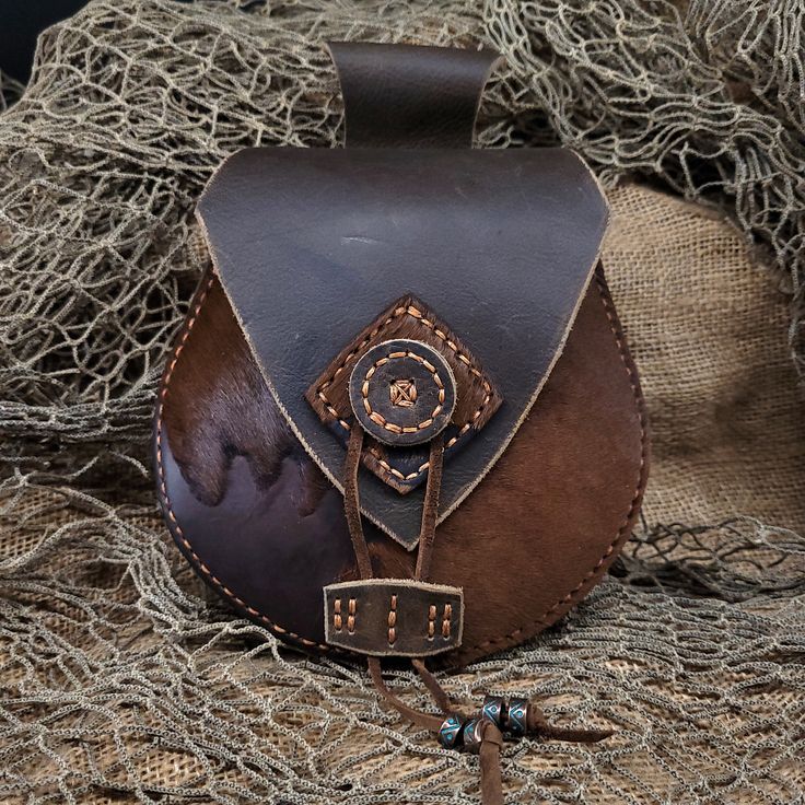 "Discover \"Ravens of Floki\" Leather Bags - a fusion of Nordic and Renaissance style, perfect for Medieval, Renaissance festivals, Burning Man, and rodeos. **Functional Elegance Handmade with love, these bags effortlessly slide onto your belt (upto a 3 inch belt) for style and convenience. **Limited Availability Rich brown Buffalo hides with acid-washed skins - each one unique. **Handmade, Hand-Stitched Crafted stitch by stitch, a testament to our dedication to quality. Elevate your style with Ren Faire Belt Bag, Fantasy Pouch Belt, Medieval Belt Bag, Viking Belt Pouch, Handmade Medieval Pouch For Larp, Medieval Leather Pouch For Larp, Handmade Leather Belt Bag For Larp, Leather Belt Bag Medieval, Medicine Bag