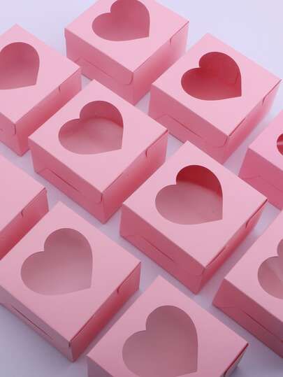 several pink boxes with hearts cut out of them