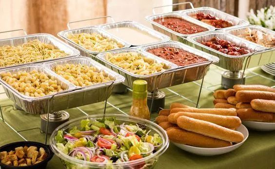 a table topped with lots of trays filled with different types of foods and condiments