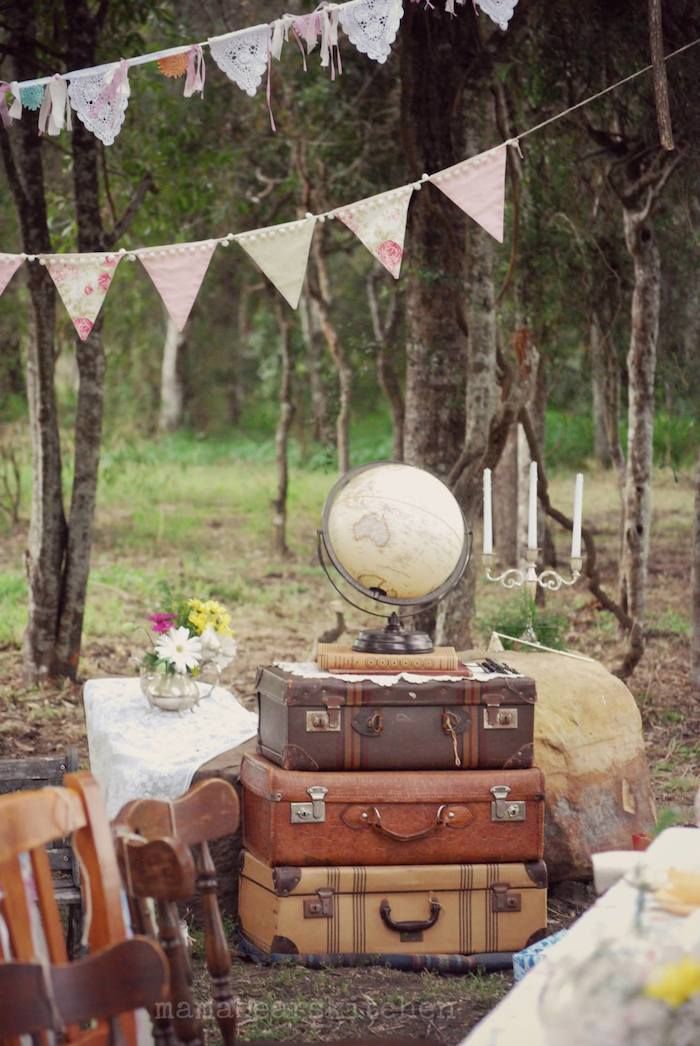 several suitcases stacked on top of each other in front of flags and bunting