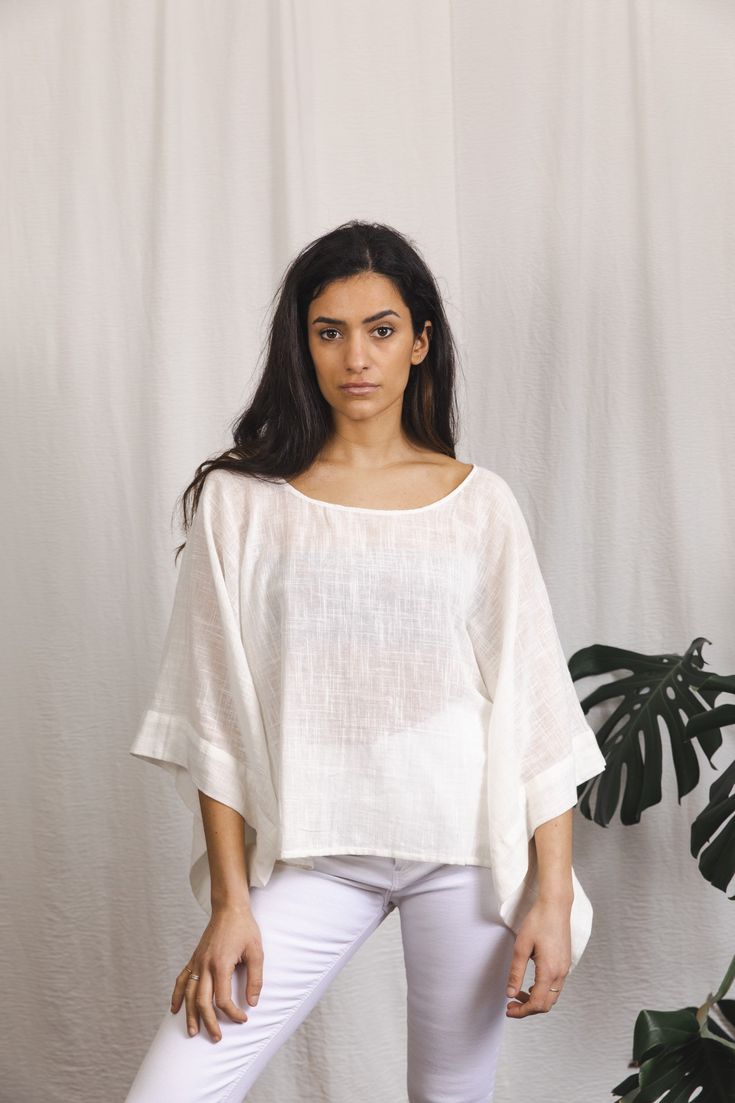 Beautiful cotton top with a textured finish. Wing sleeves Free size Oversized Cotton Short Sleeve Knit Top, Oversized Cotton Knit Top With Short Sleeves, White Cotton Tunic Shirt, Casual Cotton Tunic Top, Oversized Tunic Top For Vacation, Relaxed White Tops For Vacation, Oversized Cotton Top For Vacation, Spring Off White Crew Neck Tops, White Relaxed Fit Blouse With Crew Neck