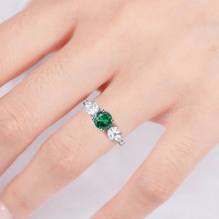 Make your style known with our breathtaking Ada emerald ring. Made on a base of Sterling Silver 925 and finished with a beautiful center emerald, this bold contrast will add a unique luxury to any outfit. Plus, our gorgeous CZ crystals further accentuate the shine, giving you a design you’ll simply adore. ✦ DETAILS ✦✧ Handcrafted ✧ 0.75 Carat center stone✧ Emerald and cz crystals ✧ Sizes 3.5-11✧ Rose gold over sterling silver 925, gold over sterling silver 925, or sterling silver 925 Fine Jewelry Emerald Ring With Cubic Zirconia, Fine Jewelry Emerald Ring With Accent Stones, Fine Jewelry Cubic Zirconia Emerald Ring With Accent Stones, Dazzling Green Emerald Ring Gift, Silver Emerald Ring For Proposal, Fine Jewelry Emerald Crystal Ring With Accent Stones, Elegant Green Birthstone Ring In Sterling Silver, Elegant Green Sterling Silver Birthstone Ring, Classic Silver Emerald Ring For Proposal