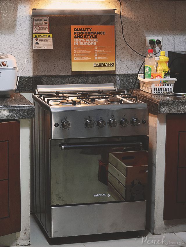 a stove top oven sitting inside of a kitchen