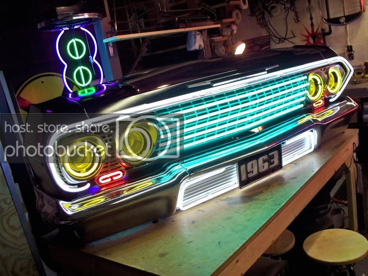 an old car with neon lights on it's headlight is sitting on a table