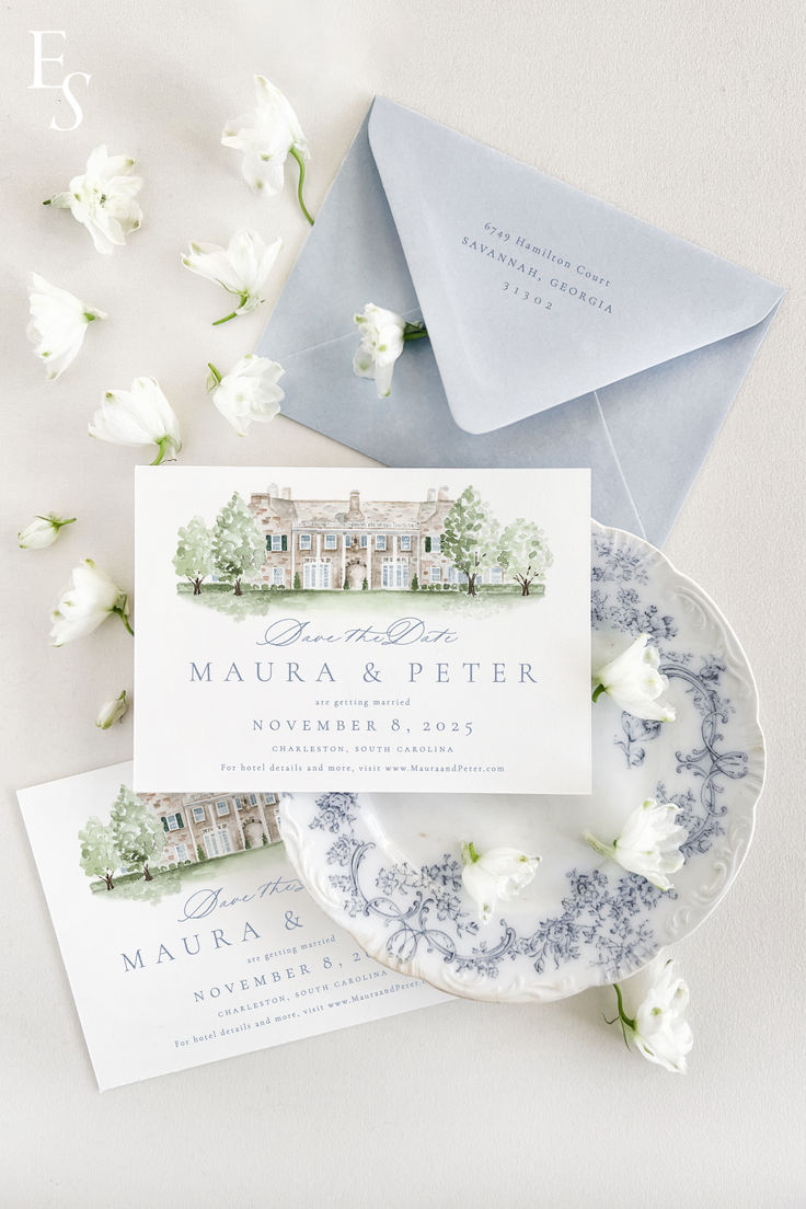 the wedding stationery is laid out on top of an envelope and plate with flowers