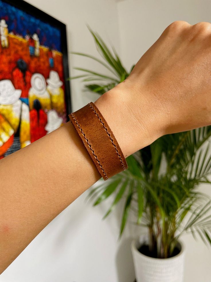 Beautiful Guatemalan authentic leather bracelet.Handcrafted by local artisans in Guatemala.Featuring two sturdy snap fasteners at one end and stitched detailing to the circumference of the band.3 different colors-rich brown-tan-blue Each piece is handmade featuring a unique design.As a unique handmade product each product may vary.MEASUREMENTSsizes S,M,LEach size has different width.S: Length- 7.8" Width- 0.8"M: Length- 8.3" Width- 0.6"L: Length- 8.5" Width- 0.7"Each may vary a little.MATERIALCo Everyday Leather Wristband With Leather Strap, Leather Wristband For Everyday Use, Everyday Leather Wristband With Strap, Everyday Leather Wristband, Leather Bracelet With Wrist Strap For Everyday Use, Everyday Leather Wristband With Bracelet Strap, Handmade Leather Bracelets For Everyday, Handmade Leather Bracelet For Everyday, Everyday Handmade Leather Bracelets