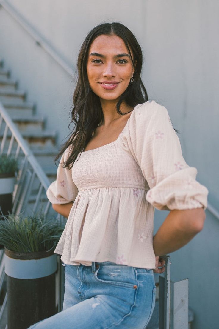 This sweet woven cotton gauze babydoll features a square neck with 3/4 sleeves and delicate flower embroidered detailing. Color: Almond Smocking Hand wash cold Spring Feminine Peasant Top With Smocked Bodice, Spring Smocked Top With Square Neck, Feminine Spring Peasant Top With Smocked Back, Spring Feminine Peasant Top With Smocked Cuffs, Feminine Smocked Square Neck Top For Brunch, Feminine Smocked Top With Square Neck For Brunch, Summer Peasant Top With Smocked Back And Square Neck, Summer Peasant Top With Square Neck And Smocked Back, Spring Square Neck Smocked Top For Brunch