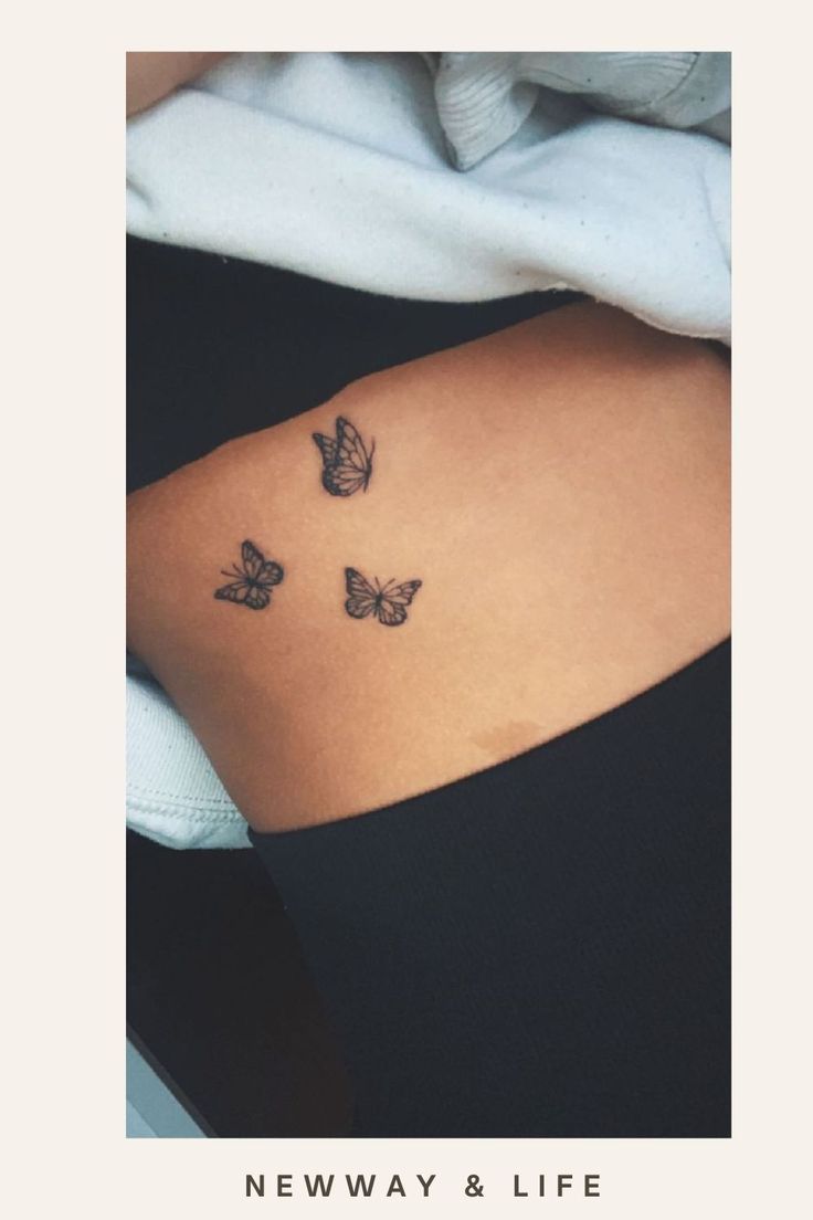 three butterflies on the back of a woman's left side ribcage, with text new way and life written below