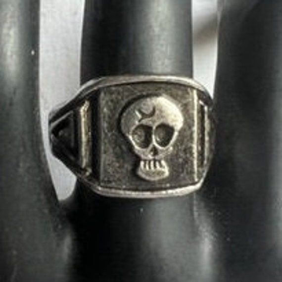 This is a vintage SKULL DESIGN PEWTER RING, size 8-1/4. The shank is 5/8" wide at the top and 28" wide at the bottom with a split shank.  Good vintage condition.   IMPORTANT - PLEASE READ: ~ ~ ~ ~ ~ ~ ~ ~ ~ ~ ~ ~ ~ ~ ~ ~ ~ ~ ~ ~ ~ ~ ~ ~ ~ ~ ~ ~ ~ ~ ~ ~ ~ ~ ~ ~ ~ ~  VINTAGE:  This is a vintage item [20 years of age or older] and therefore may show some wear due to age; vintage items have been previously owned and are rarely in perfect condition.  Effort is always made to note any defects or damage. SHIPPING/HANDLING: Shipping may be by your choice of Priority Mail or Ground Advantage.  PLEASE SELECT ONE:        -- Priority Mail (with insurance for loss or damage during mail transit); postal delivery usually in 1-3 business days.        -- Ground Advantage (with insurance for loss or damage Vintage Black Rings For Halloween, Vintage Handmade Skull Ring, Vintage Adjustable Black Skull Ring, Handmade Adjustable Vintage Skull Ring, Handmade Vintage Rings For Halloween, Handmade Vintage Halloween Rings, Vintage Silver Skull Ring, Vintage Adjustable Silver Skull Ring, Handmade Vintage Black Skull Ring