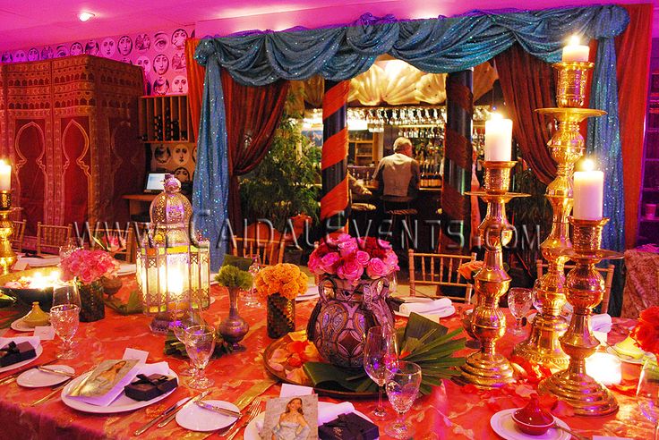 an elaborately decorated table with candles and flowers