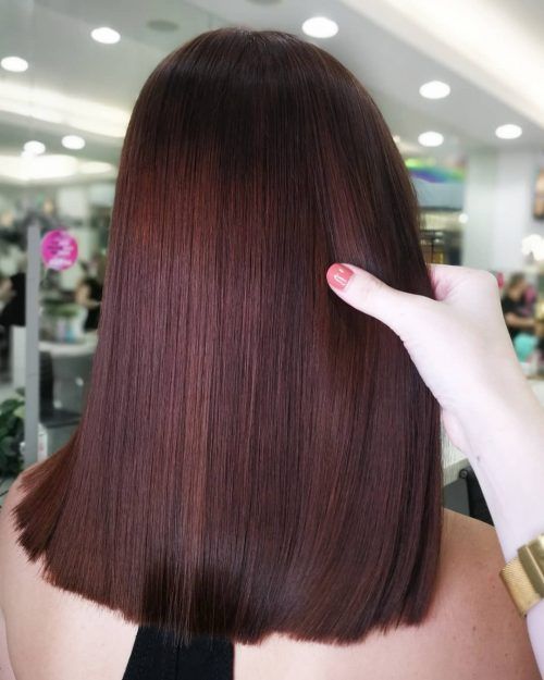 the back of a woman's head with long, straight hair in front of her