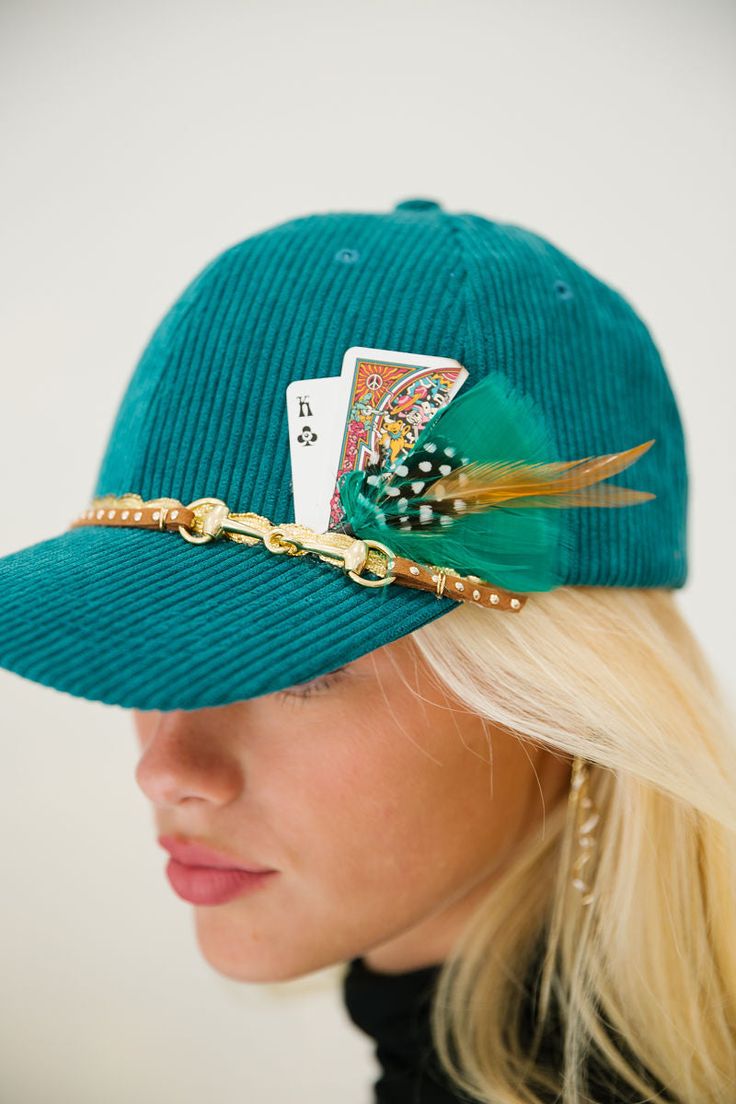 Rock the KING ME Corduroy Hat and rule the streets! This fierce piece of headgear features a teal corduroy hat, a dazzling gold horse bit band, and some unique feathers to add some extra oomph. Show 'em who's boss with this show-stopper that's sure to turn heads! This is a made-to-order item. All customized orders are currently shipping within 14 business days. To receive item quicker, expedited shipping is available at checkout. **CARDS MAY VARY** Cheap Fun Customizable Hats, Custom Cowboy Hats, Mad Hat, Dope Hats, Corduroy Hat, Custom Trucker Hats, Painted Hats, Gold Horse, Diy Clothes Design