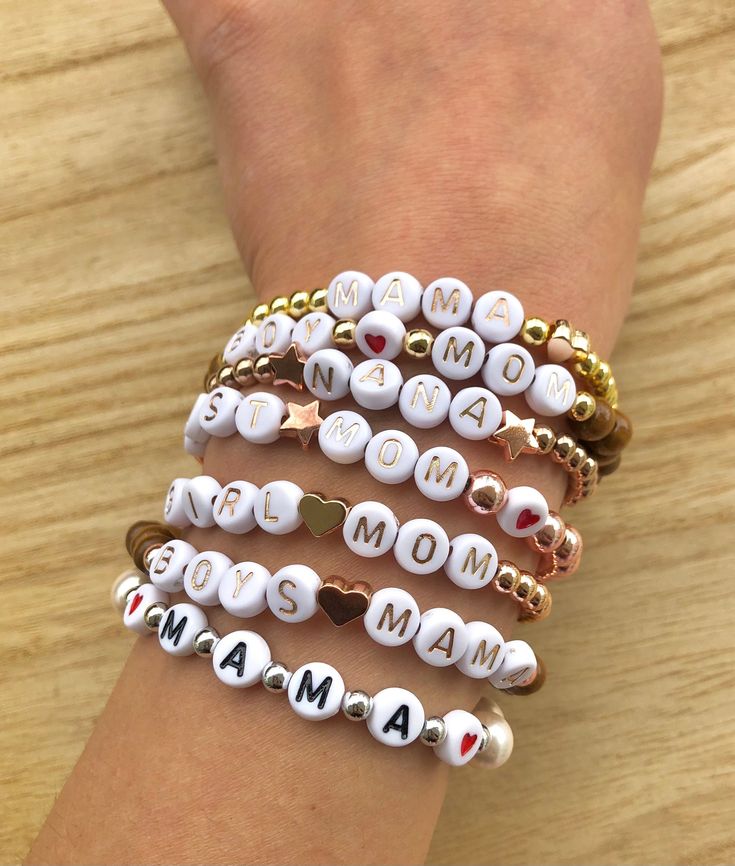 four bracelets with words on them that say mom and i love you in different languages