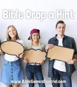 four people holding up signs with the words bible drop a hint in front of them