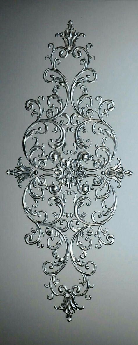 an intricately designed piece of metal on a gray background with the wording in silver